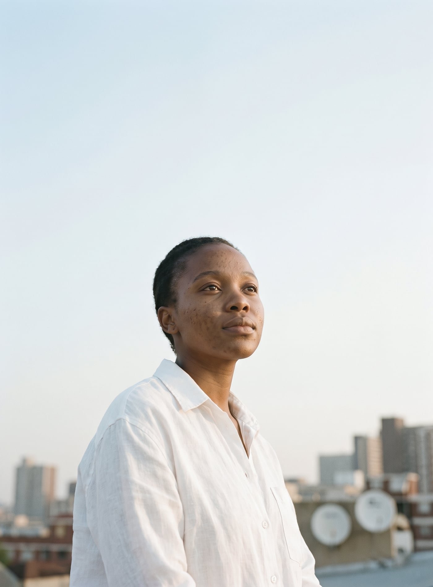 Woman on a Johannesburg rooftop looking into the sky